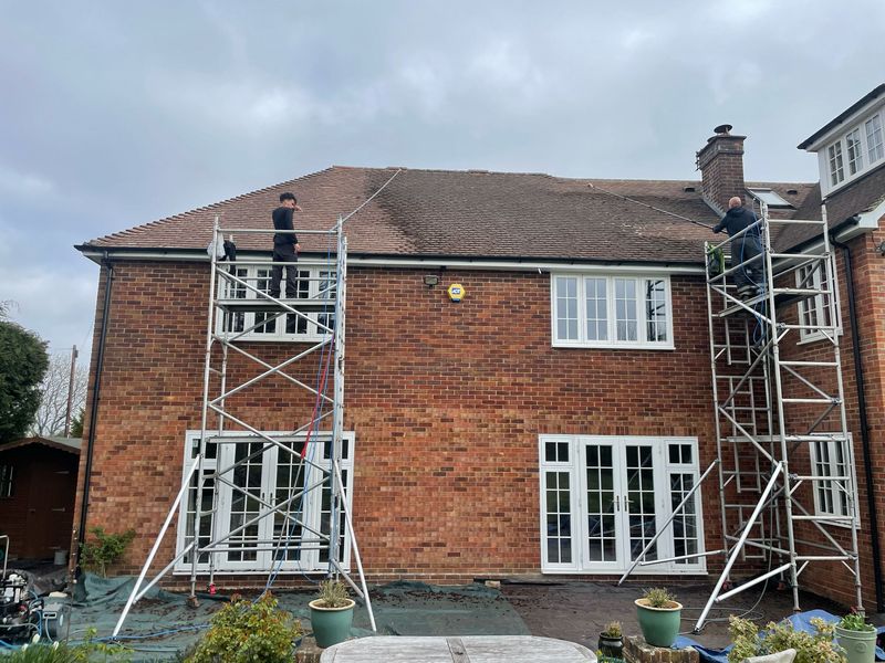 Roof cleaning carried out safely from scaffold towers by The Roof Moss Cleaners in Higham Ferrers